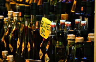 bottles of olive oil are on display in a store